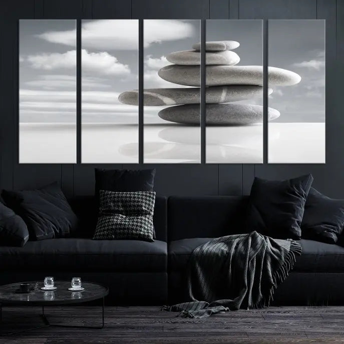 A gallery-quality Still Life Black and White Zen Stones Wall Art Canvas Print, featuring a triptych of stacked stones against a calm, cloudy background, adorns the room to bring an elegant touch.