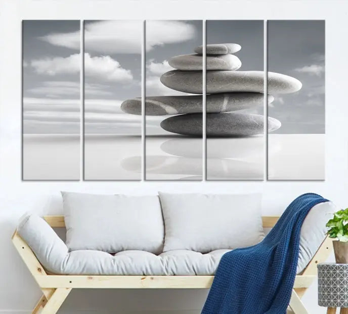 A gallery-quality Still Life Black and White Zen Stones Wall Art Canvas Print, featuring a triptych of stacked stones against a calm, cloudy background, adorns the room to bring an elegant touch.