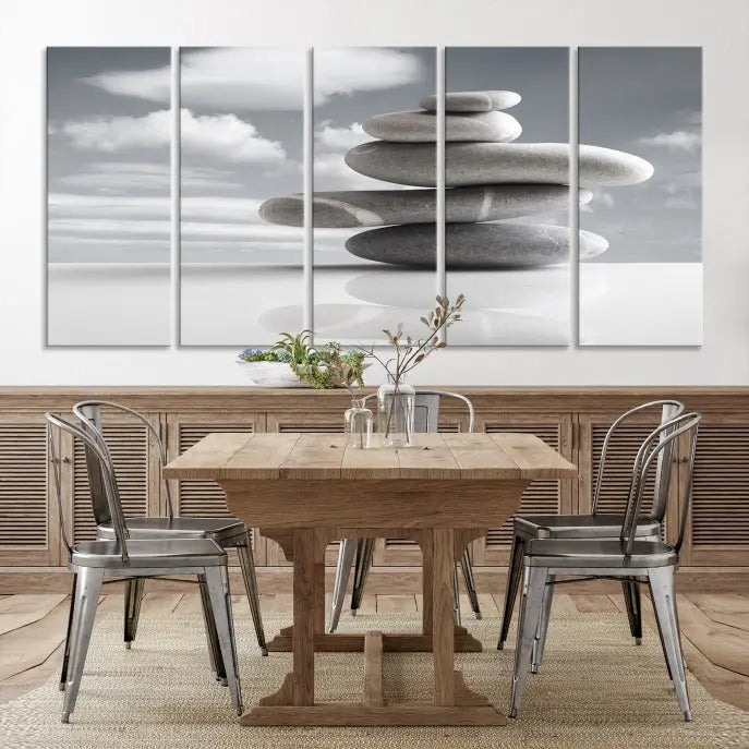 A gallery-quality Still Life Black and White Zen Stones Wall Art Canvas Print, featuring a triptych of stacked stones against a calm, cloudy background, adorns the room to bring an elegant touch.