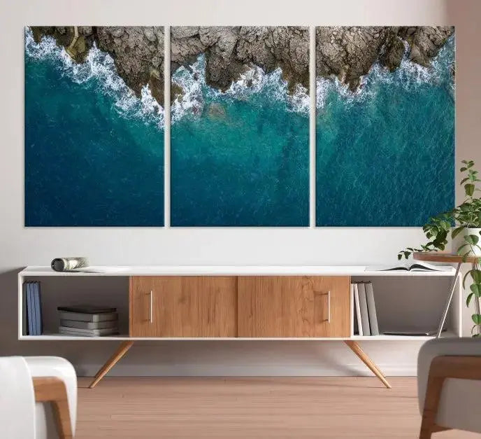 The wall is adorned with the Stone and Aerial Beach Wall Art Canvas Print, crafted by professional artisans, contributing an air of sophistication to the space.