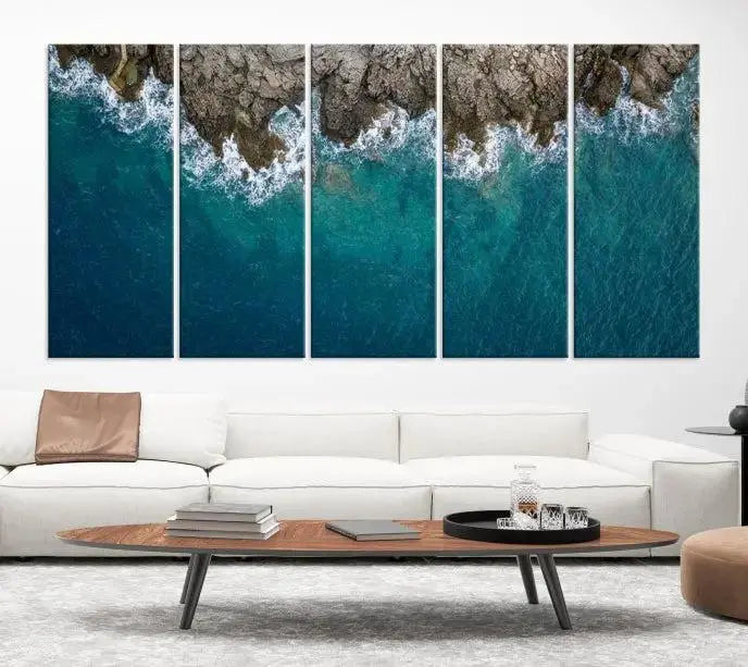 The wall is adorned with the Stone and Aerial Beach Wall Art Canvas Print, crafted by professional artisans, contributing an air of sophistication to the space.