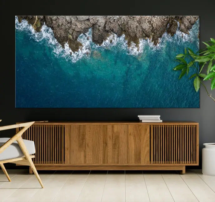 The wall is adorned with the Stone and Aerial Beach Wall Art Canvas Print, crafted by professional artisans, contributing an air of sophistication to the space.