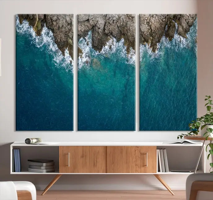 The wall is adorned with the Stone and Aerial Beach Wall Art Canvas Print, crafted by professional artisans, contributing an air of sophistication to the space.