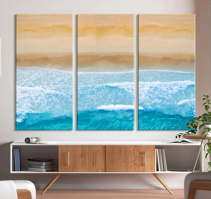 The Stunning Aerial Beach Canvas Print Wall Art, depicting turquoise waves and golden sand, is printed on museum-quality canvas.