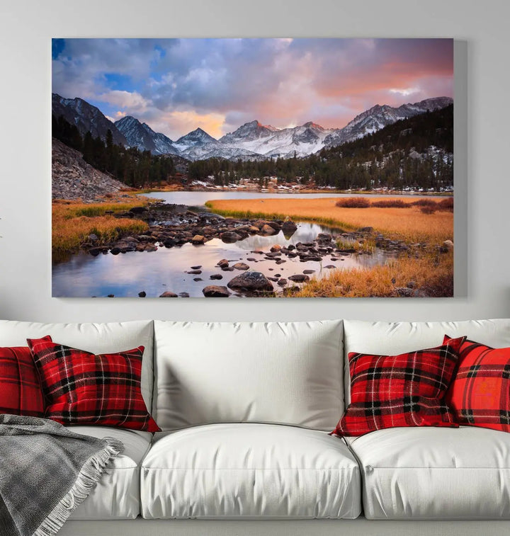 The living room features the Stunning Mountain Landscape Canvas Wall Art Print, a museum-quality triptych painting on UV-protective canvas that depicts majestic mountains and a serene river.