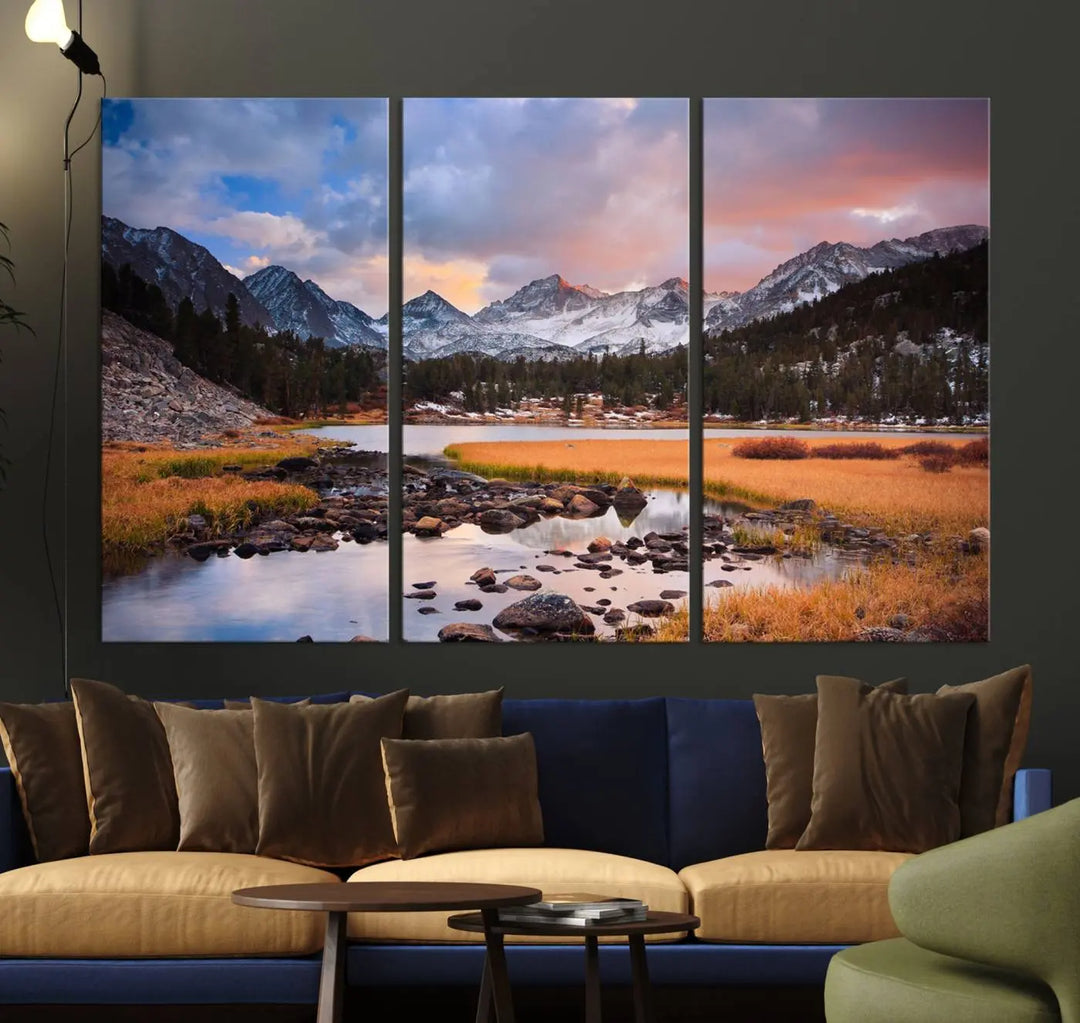 The living room features the Stunning Mountain Landscape Canvas Wall Art Print, a museum-quality triptych painting on UV-protective canvas that depicts majestic mountains and a serene river.