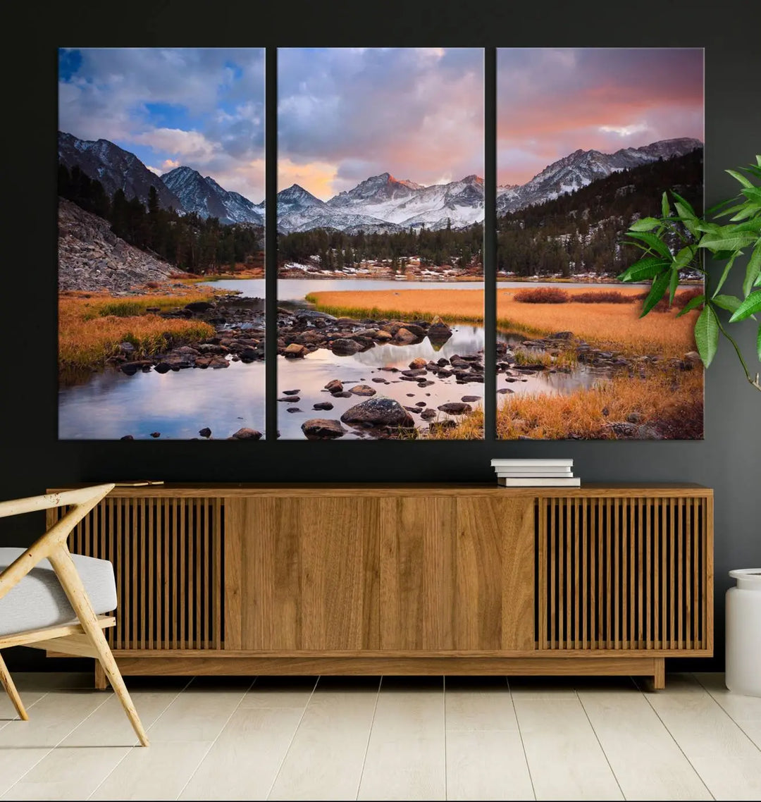 The living room features the Stunning Mountain Landscape Canvas Wall Art Print, a museum-quality triptych painting on UV-protective canvas that depicts majestic mountains and a serene river.