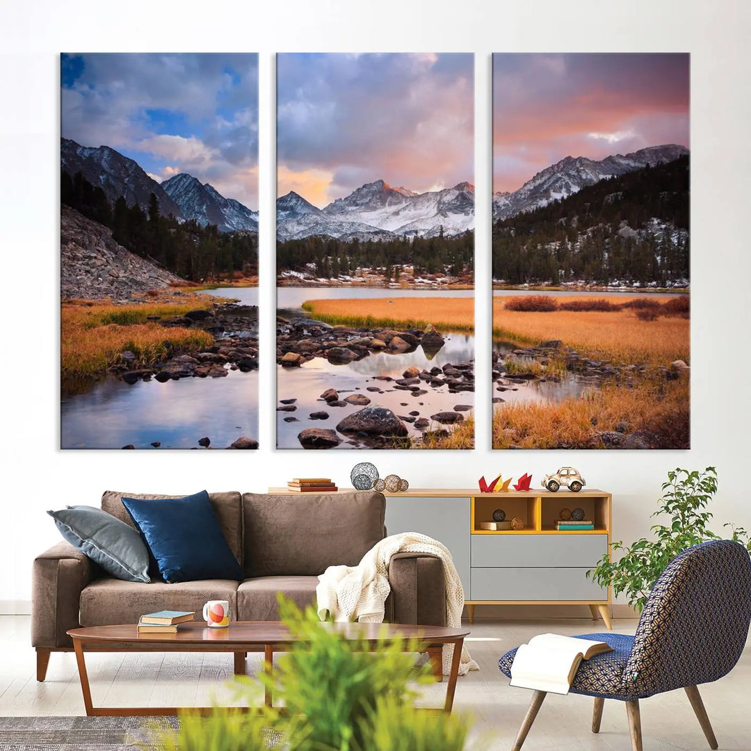 The living room features the Stunning Mountain Landscape Canvas Wall Art Print, a museum-quality triptych painting on UV-protective canvas that depicts majestic mountains and a serene river.