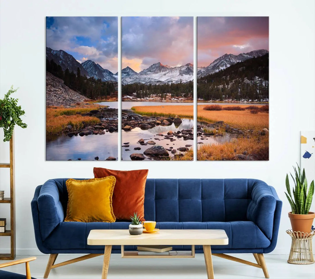 The living room features the Stunning Mountain Landscape Canvas Wall Art Print, a museum-quality triptych painting on UV-protective canvas that depicts majestic mountains and a serene river.