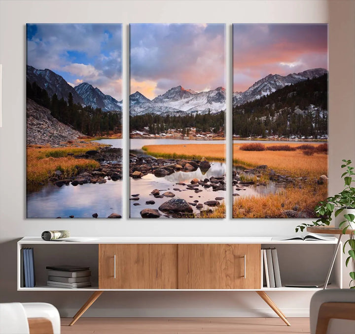 The living room features the Stunning Mountain Landscape Canvas Wall Art Print, a museum-quality triptych painting on UV-protective canvas that depicts majestic mountains and a serene river.