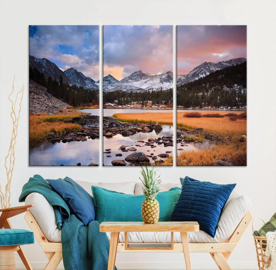 The living room features the Stunning Mountain Landscape Canvas Wall Art Print, a museum-quality triptych painting on UV-protective canvas that depicts majestic mountains and a serene river.