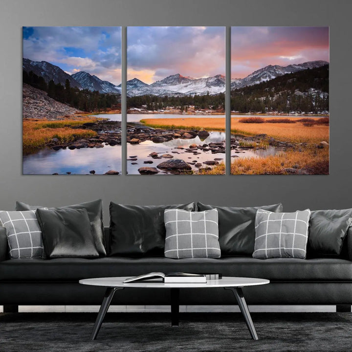 The living room features the Stunning Mountain Landscape Canvas Wall Art Print, a museum-quality triptych painting on UV-protective canvas that depicts majestic mountains and a serene river.