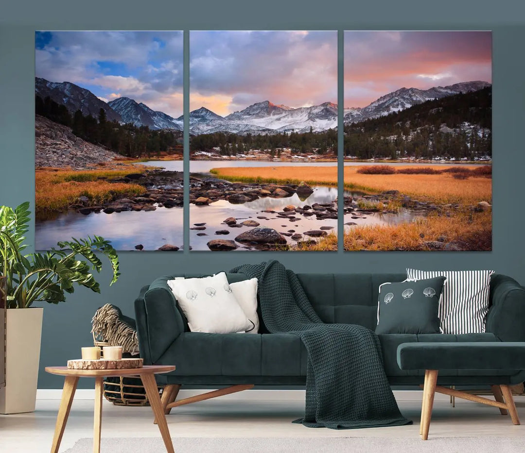 The living room features the Stunning Mountain Landscape Canvas Wall Art Print, a museum-quality triptych painting on UV-protective canvas that depicts majestic mountains and a serene river.