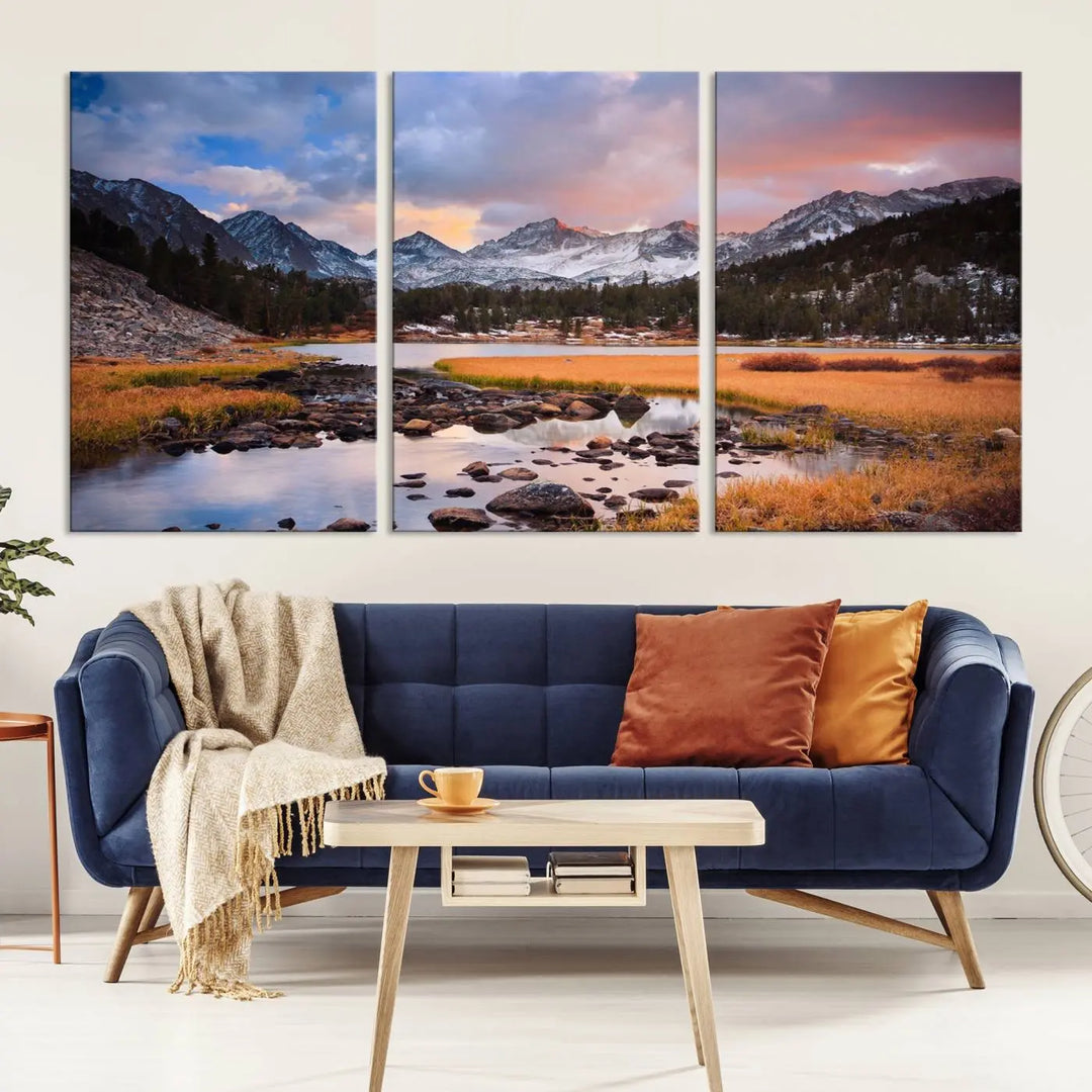 The living room features the Stunning Mountain Landscape Canvas Wall Art Print, a museum-quality triptych painting on UV-protective canvas that depicts majestic mountains and a serene river.