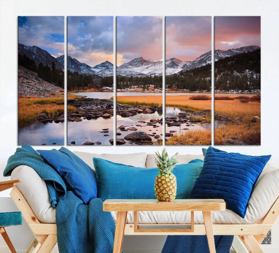 The living room features the Stunning Mountain Landscape Canvas Wall Art Print, a museum-quality triptych painting on UV-protective canvas that depicts majestic mountains and a serene river.