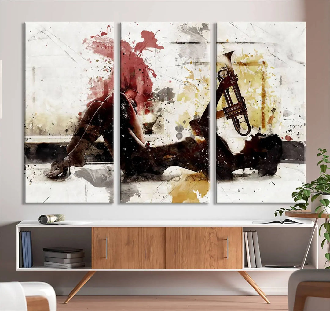 Introducing the Stylish Jazz Woman with Trumpet Triptych Canvas Art: This modern abstract wall décor features a captivating painting of a person lying with a trumpet, set against an abstract background with dynamic red and yellow splashes. This triptych artwork beautifully captures the essence of music and emotion in vibrant colors.