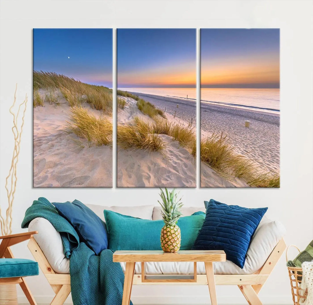 A modern living room showcases the "Sunrise On The Beach Wall Art Canvas Print" as a triptych above white cabinets. These ready-to-hang pieces are crafted on museum-quality canvas with a UV-protective coating, ensuring lasting vibrancy and elegance.