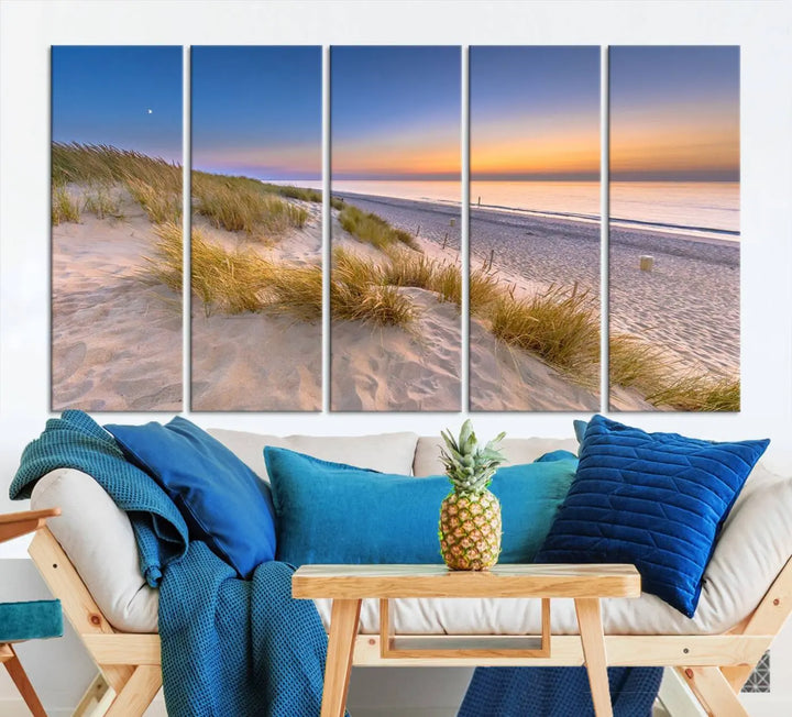 A modern living room showcases the "Sunrise On The Beach Wall Art Canvas Print" as a triptych above white cabinets. These ready-to-hang pieces are crafted on museum-quality canvas with a UV-protective coating, ensuring lasting vibrancy and elegance.