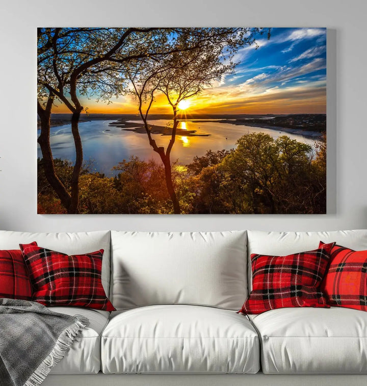 The quad panel nature print titled "Sunrise Over the River Canvas Wall Art" showcases a picturesque sunrise over a river, framed by trees.