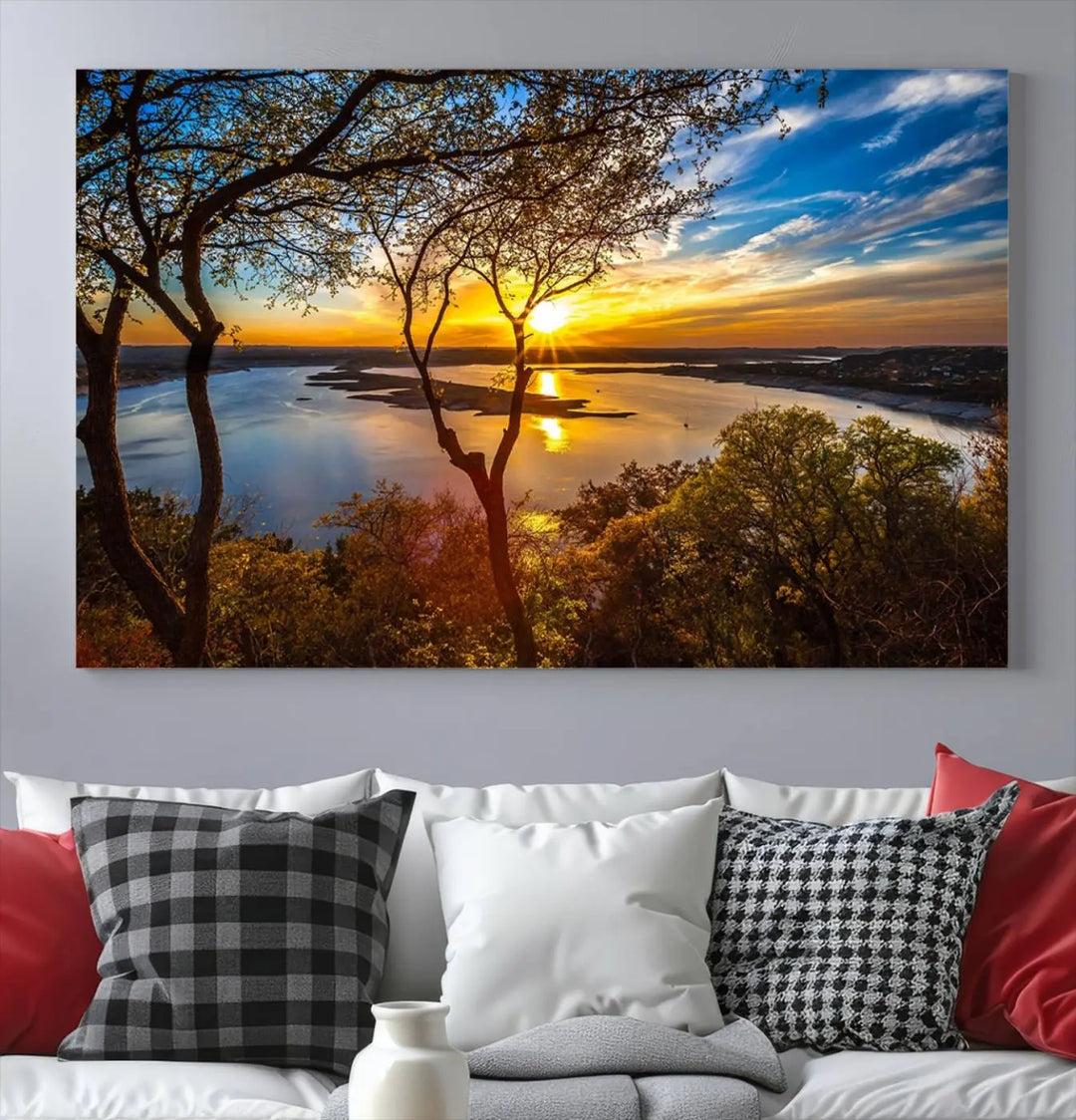 The quad panel nature print titled "Sunrise Over the River Canvas Wall Art" showcases a picturesque sunrise over a river, framed by trees.