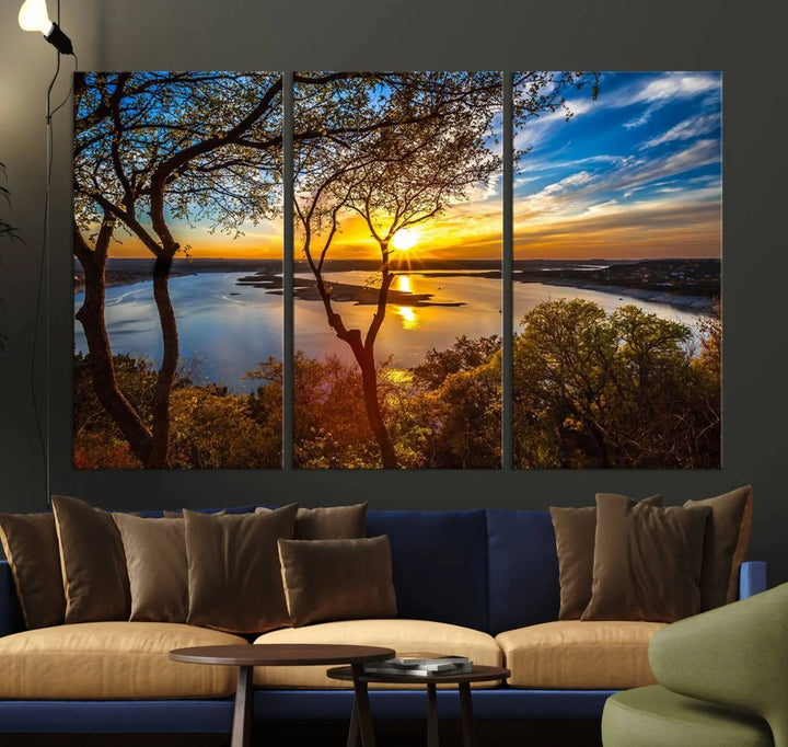 The quad panel nature print titled "Sunrise Over the River Canvas Wall Art" showcases a picturesque sunrise over a river, framed by trees.