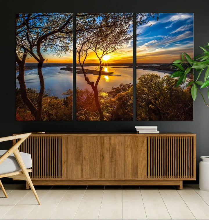 The quad panel nature print titled "Sunrise Over the River Canvas Wall Art" showcases a picturesque sunrise over a river, framed by trees.