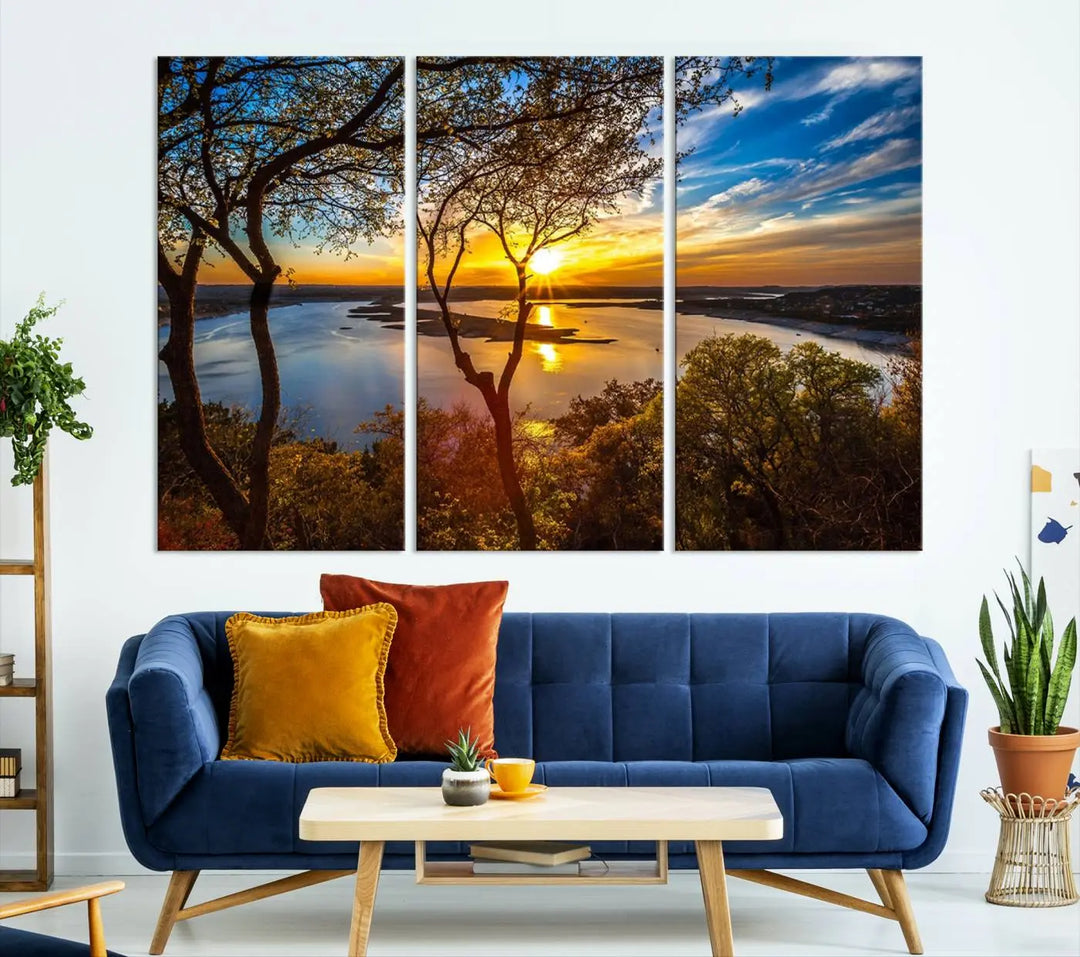 The quad panel nature print titled "Sunrise Over the River Canvas Wall Art" showcases a picturesque sunrise over a river, framed by trees.