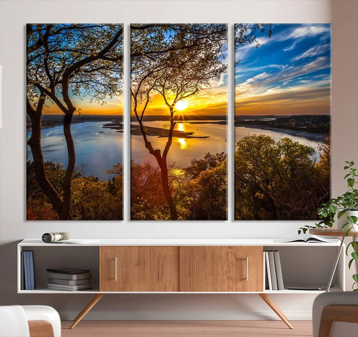 The quad panel nature print titled "Sunrise Over the River Canvas Wall Art" showcases a picturesque sunrise over a river, framed by trees.