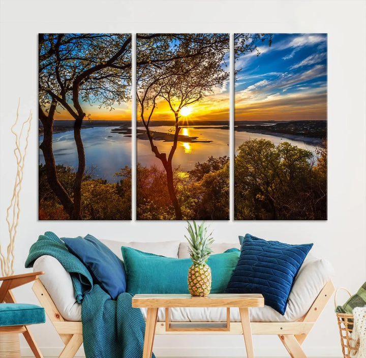 The quad panel nature print titled "Sunrise Over the River Canvas Wall Art" showcases a picturesque sunrise over a river, framed by trees.