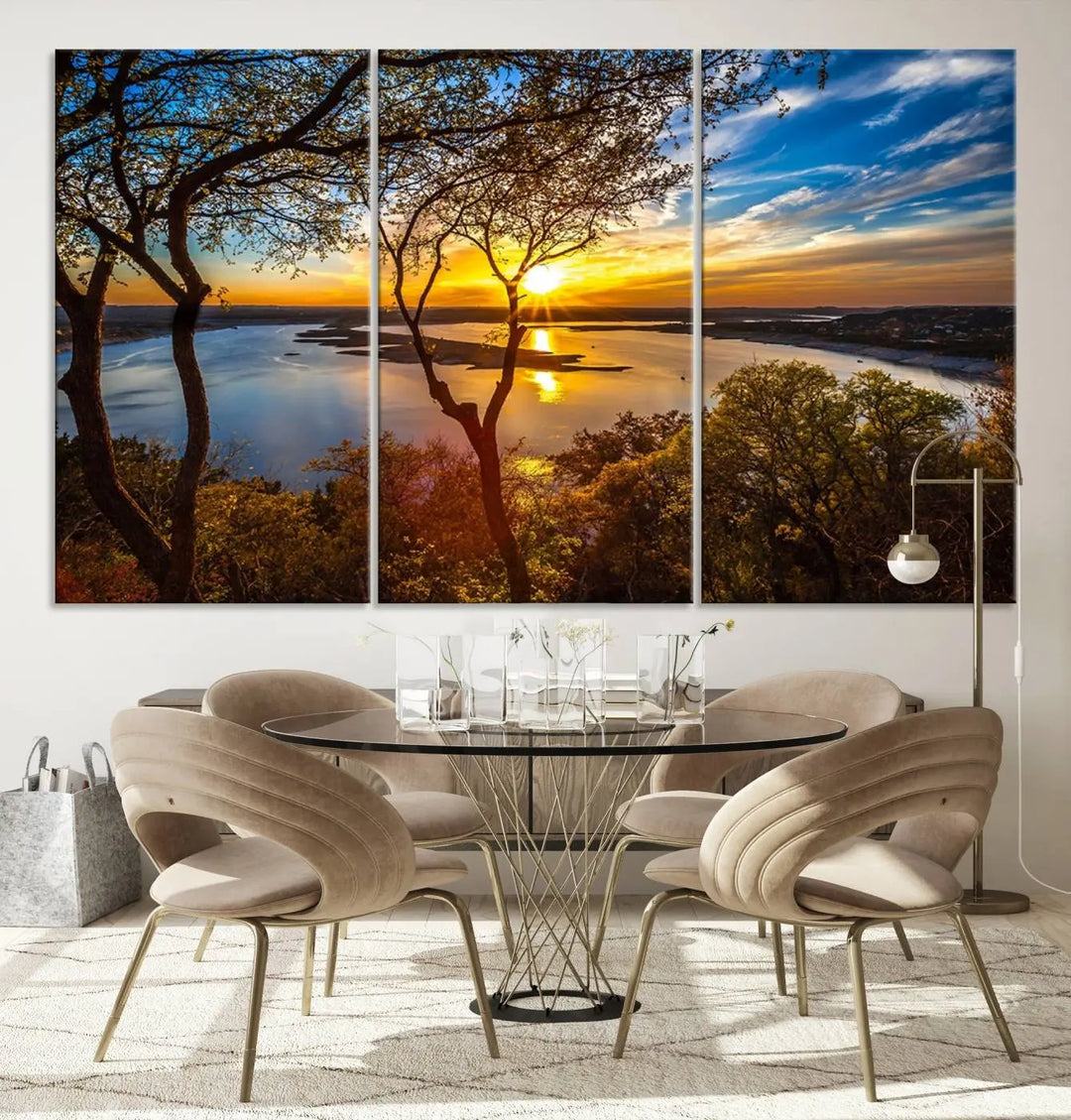 The quad panel nature print titled "Sunrise Over the River Canvas Wall Art" showcases a picturesque sunrise over a river, framed by trees.