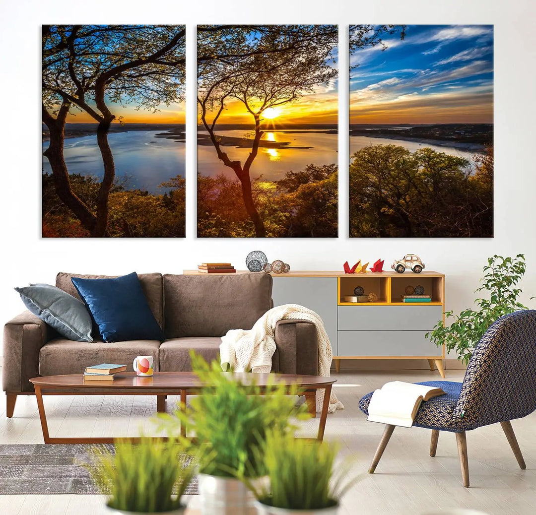 The quad panel nature print titled "Sunrise Over the River Canvas Wall Art" showcases a picturesque sunrise over a river, framed by trees.