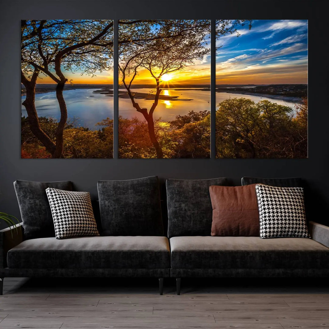 The quad panel nature print titled "Sunrise Over the River Canvas Wall Art" showcases a picturesque sunrise over a river, framed by trees.