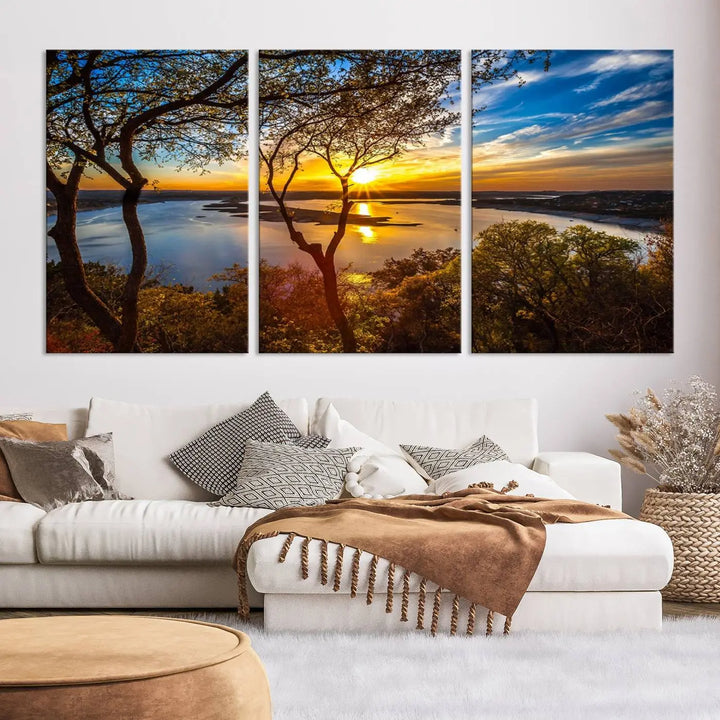 The quad panel nature print titled "Sunrise Over the River Canvas Wall Art" showcases a picturesque sunrise over a river, framed by trees.