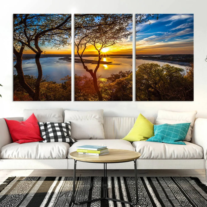 The quad panel nature print titled "Sunrise Over the River Canvas Wall Art" showcases a picturesque sunrise over a river, framed by trees.