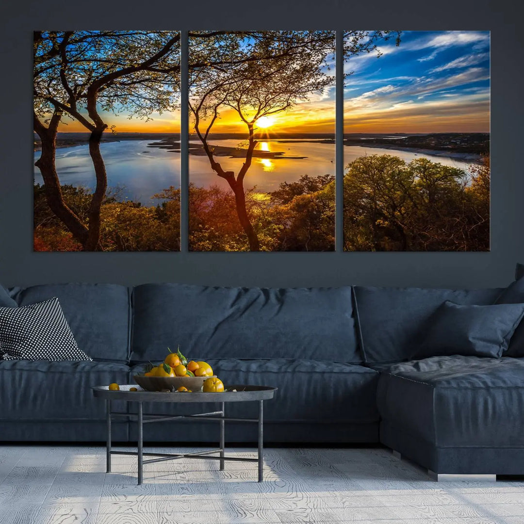 The quad panel nature print titled "Sunrise Over the River Canvas Wall Art" showcases a picturesque sunrise over a river, framed by trees.