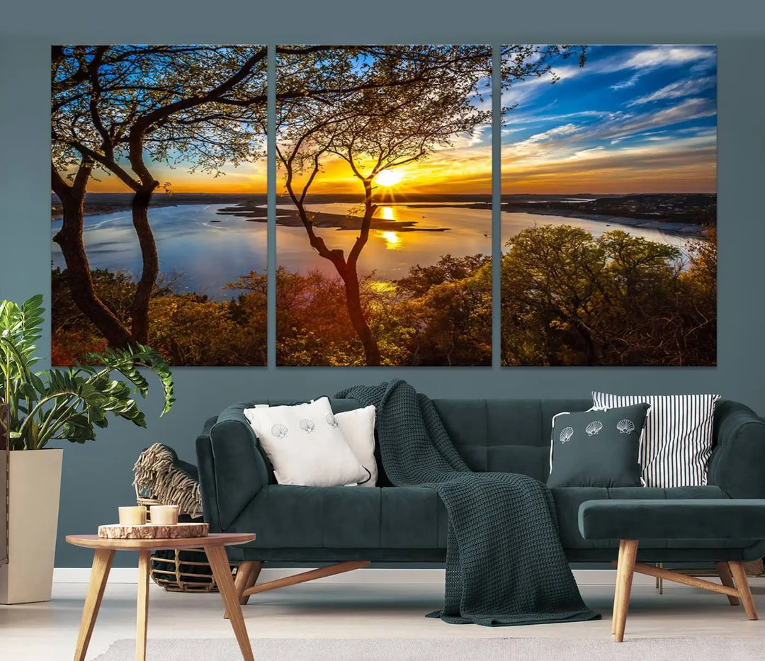 The quad panel nature print titled "Sunrise Over the River Canvas Wall Art" showcases a picturesque sunrise over a river, framed by trees.