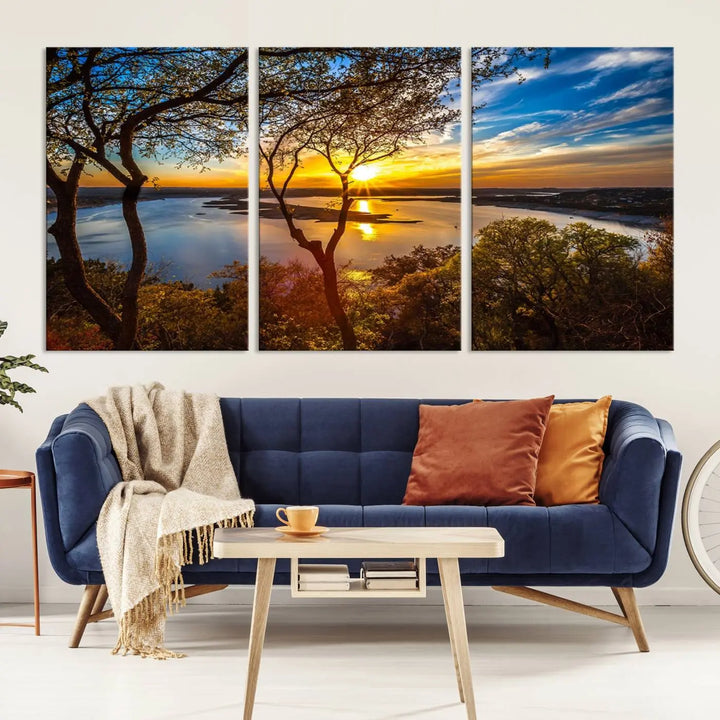 The quad panel nature print titled "Sunrise Over the River Canvas Wall Art" showcases a picturesque sunrise over a river, framed by trees.