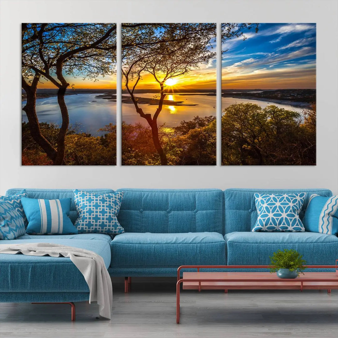 The quad panel nature print titled "Sunrise Over the River Canvas Wall Art" showcases a picturesque sunrise over a river, framed by trees.