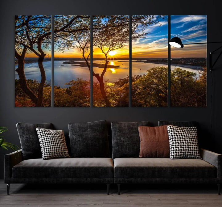 The quad panel nature print titled "Sunrise Over the River Canvas Wall Art" showcases a picturesque sunrise over a river, framed by trees.