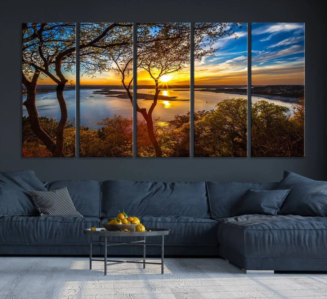 The quad panel nature print titled "Sunrise Over the River Canvas Wall Art" showcases a picturesque sunrise over a river, framed by trees.