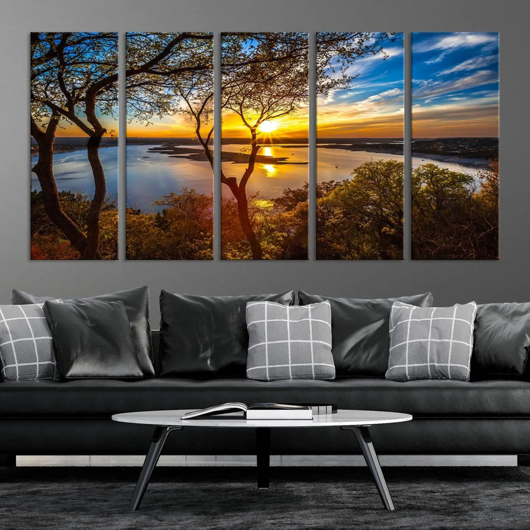 The quad panel nature print titled "Sunrise Over the River Canvas Wall Art" showcases a picturesque sunrise over a river, framed by trees.