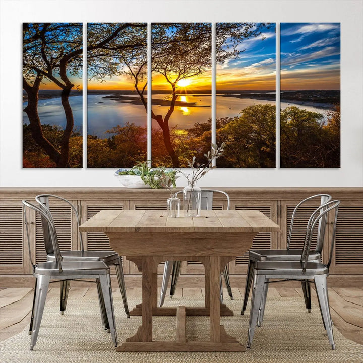 The quad panel nature print titled "Sunrise Over the River Canvas Wall Art" showcases a picturesque sunrise over a river, framed by trees.