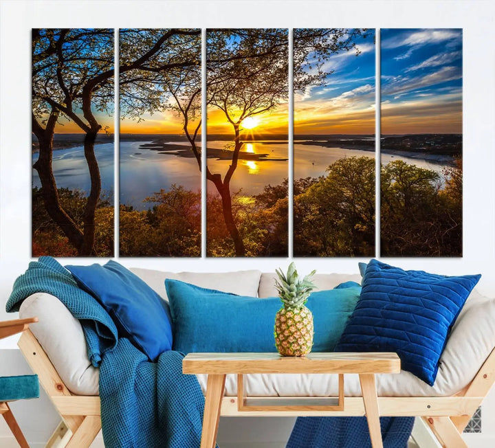 The quad panel nature print titled "Sunrise Over the River Canvas Wall Art" showcases a picturesque sunrise over a river, framed by trees.