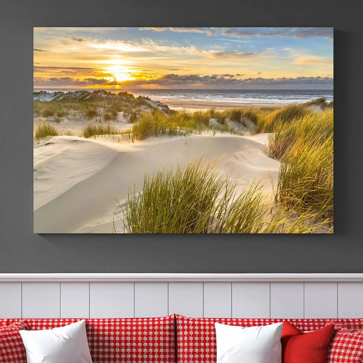 The "Sunrise on The Beach Wall Art Canvas Print" is a set of three museum-quality panels showcasing a beach sunrise with grassy dunes. Each piece includes a UV-protective coating and comes ready to hang for easy installation.