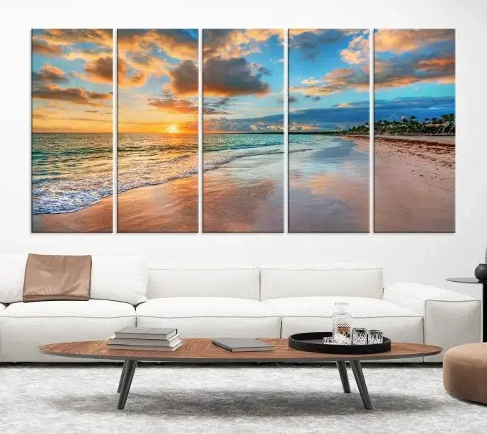 A Sunset Beach Canvas Wall Art—Tropical Triptych Seascape Print embellishes the cozy living room, enhancing the coastal ambiance with its serene ocean sunset.