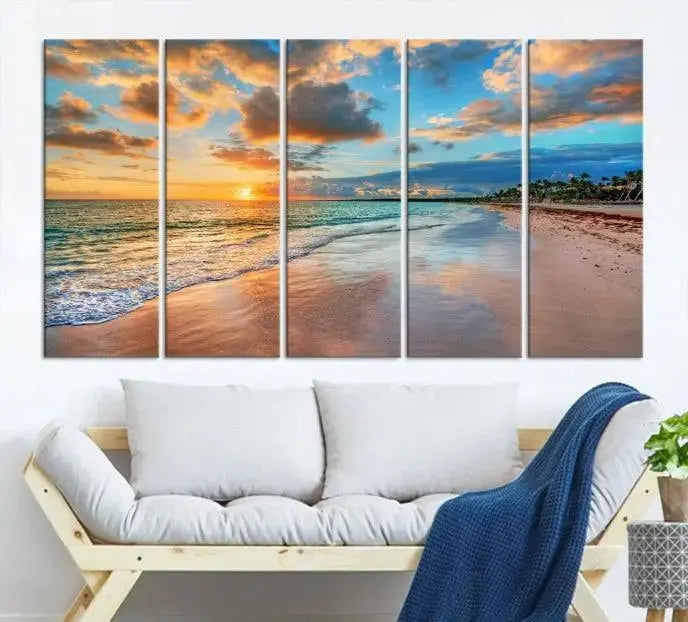 A Sunset Beach Canvas Wall Art—Tropical Triptych Seascape Print embellishes the cozy living room, enhancing the coastal ambiance with its serene ocean sunset.