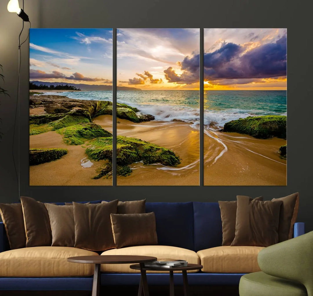 The Sunset Beach Wall Art Canvas Print is a gallery-wrapped triptych showcasing a beach scene with mossy rocks and a vibrant sunset. Made from museum-quality canvas and featuring a UV-protective coating, it elegantly provides both beauty and durability.