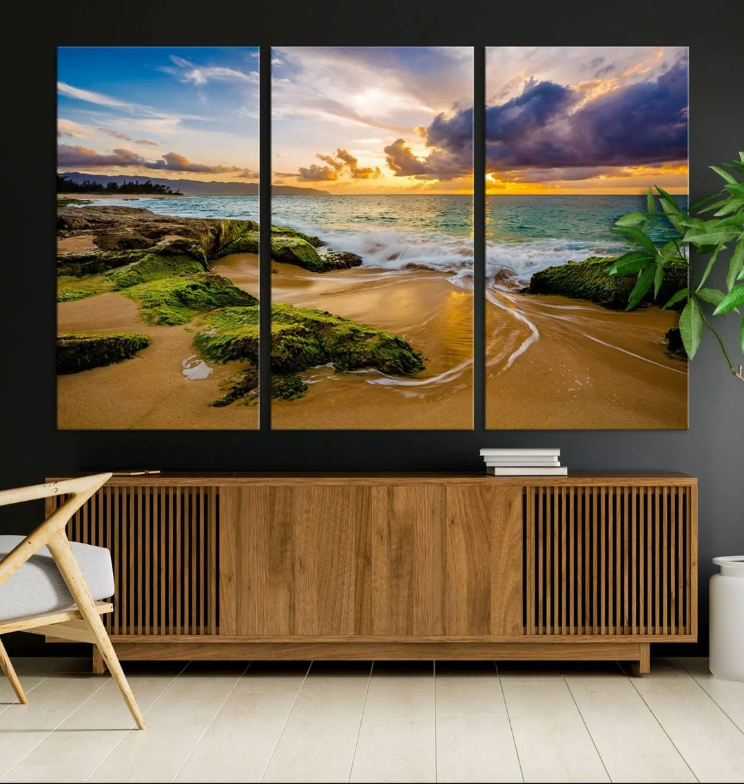 The Sunset Beach Wall Art Canvas Print is a gallery-wrapped triptych showcasing a beach scene with mossy rocks and a vibrant sunset. Made from museum-quality canvas and featuring a UV-protective coating, it elegantly provides both beauty and durability.