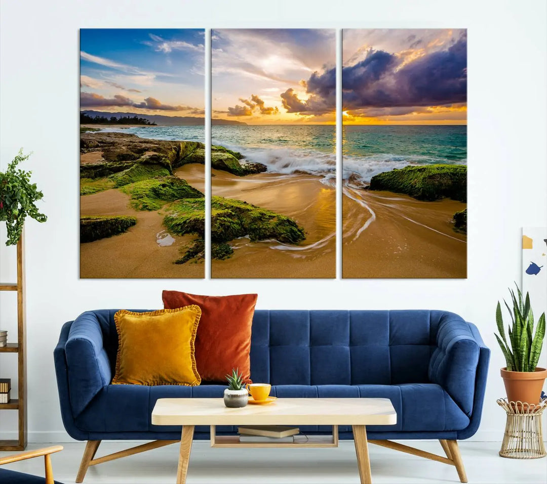 The Sunset Beach Wall Art Canvas Print is a gallery-wrapped triptych showcasing a beach scene with mossy rocks and a vibrant sunset. Made from museum-quality canvas and featuring a UV-protective coating, it elegantly provides both beauty and durability.