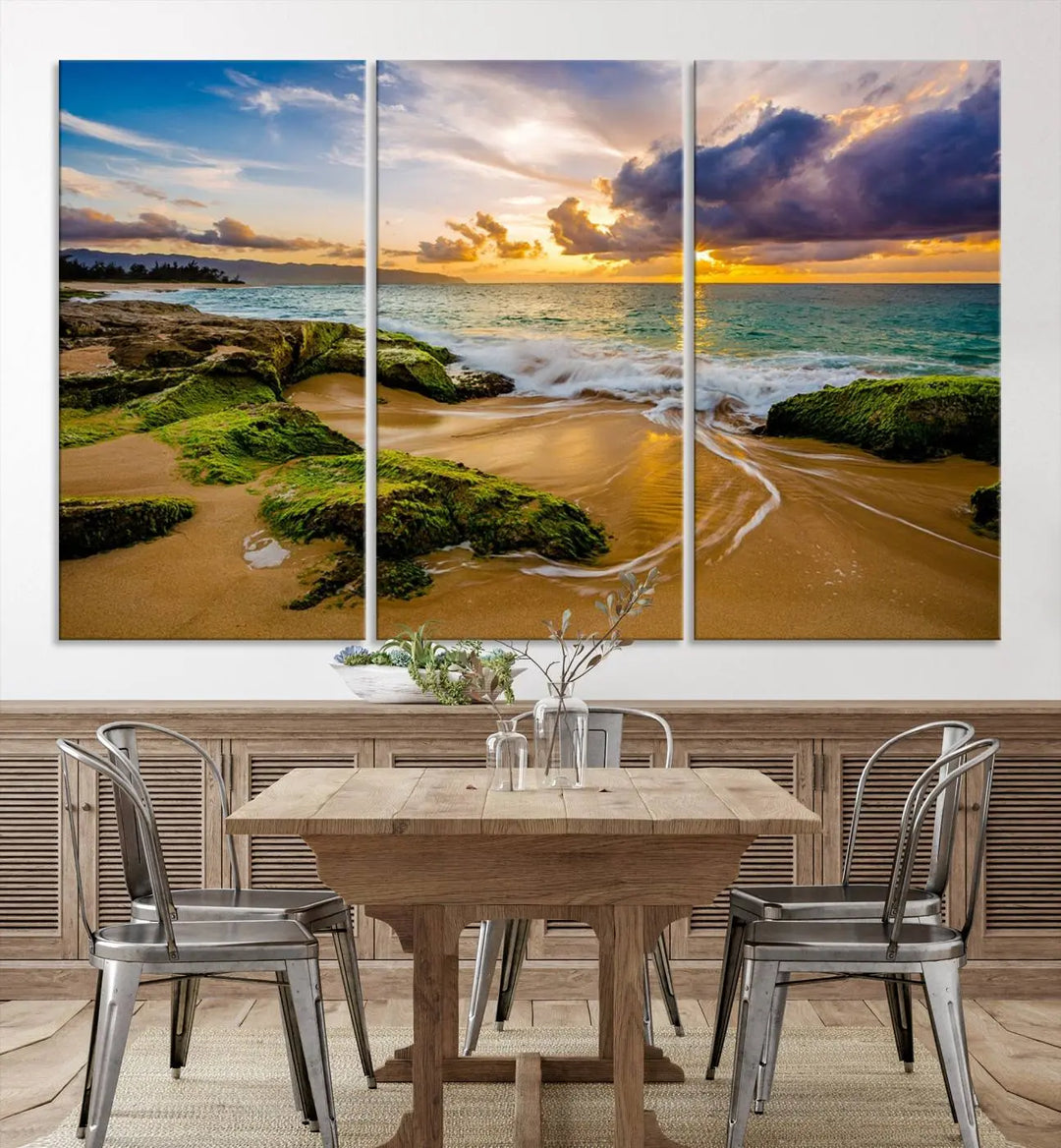 The Sunset Beach Wall Art Canvas Print is a gallery-wrapped triptych showcasing a beach scene with mossy rocks and a vibrant sunset. Made from museum-quality canvas and featuring a UV-protective coating, it elegantly provides both beauty and durability.